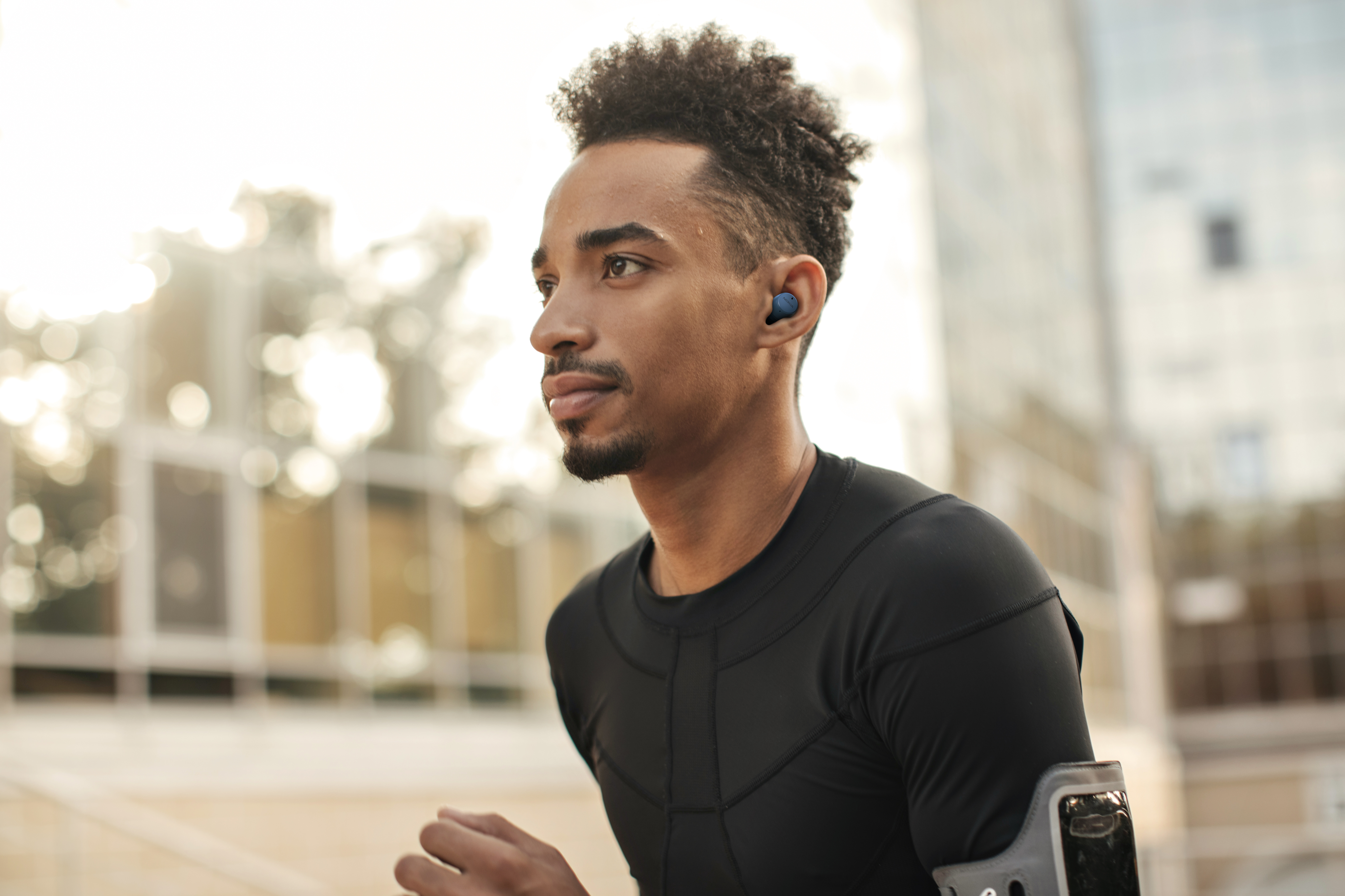 Athlete wearing Nokia earbuds outdoors